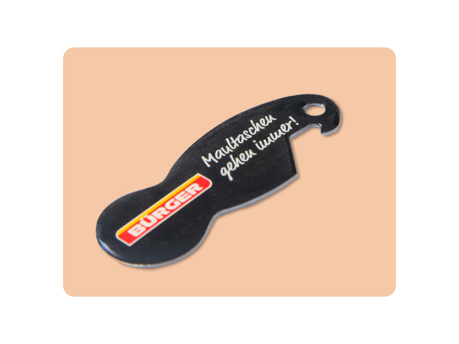 Schwarzer Flaschenöffner mit „BÜRGER“-Logo und Schriftzug „Maultaschen gehen immer!“